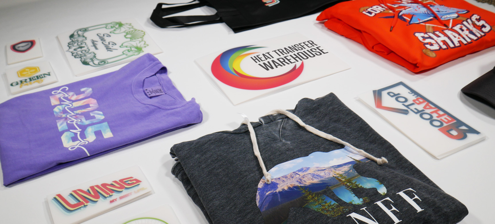 Assortment of clothes and vinyl laid out on a table.